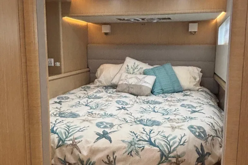 Slide: The Image of Cozy bedroom in 2022 Seaway 1600 with nautical-themed bedding and soft lighting. - 38