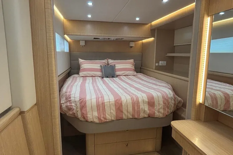 Slide: The Image of Luxurious bedroom interior of 2022 Seaway 1600 with striped bedding and ambient lighting. - 4