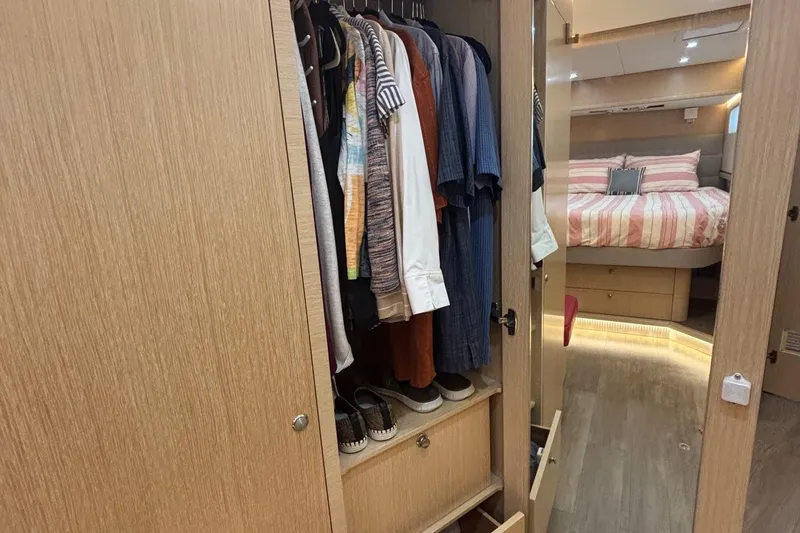 Slide: The Image of Wardrobe and bedroom interior of 2022 Seaway 1600 yacht, featuring clothes and cozy bedding. - 40