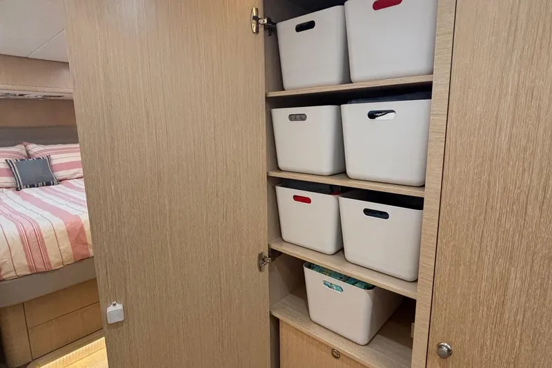 Slide: The Image of 2022 Seaway 1600 interior with organized storage bins and cozy bedroom. - 41