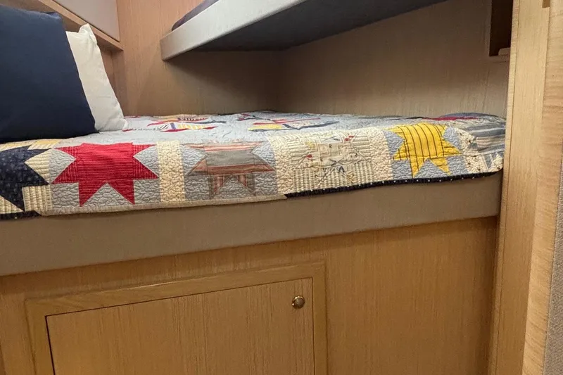 Slide: The Image of Cozy cabin bed in 2022 Seaway 1600 with colorful star-patterned quilt. - 45