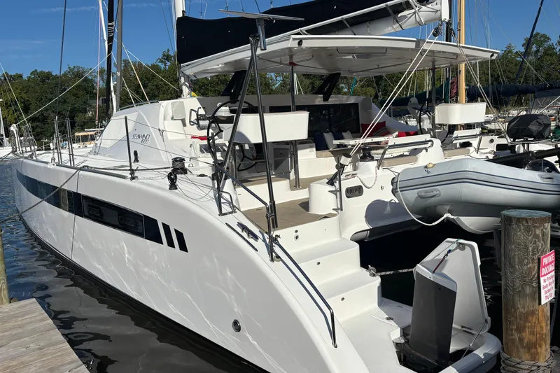 Slide: The Image of 2022 Seawind 1600 catamaran docked, featuring sleek design and modern amenities. - 49