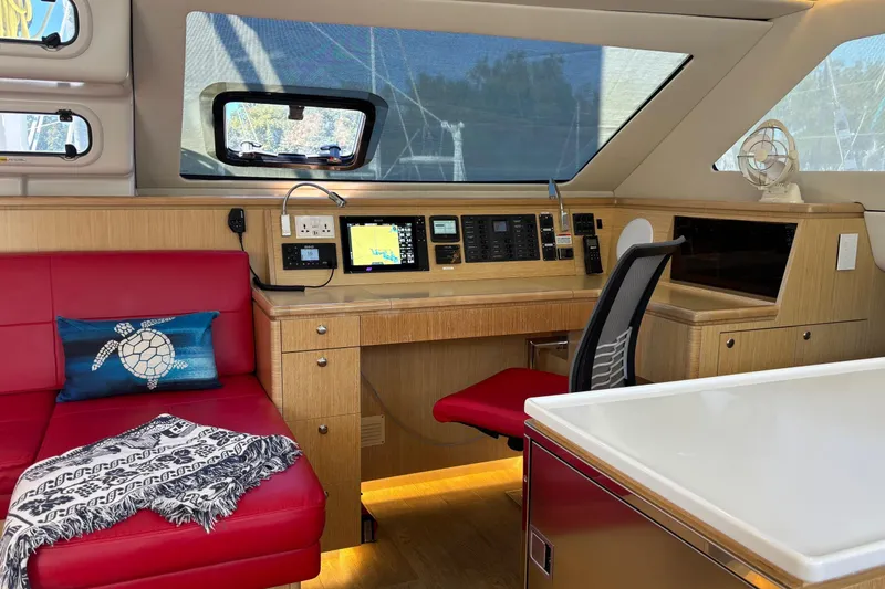 Slide: The Image of Luxurious interior of 2022 Seawind 1600 yacht with red seating and navigation station. - 5