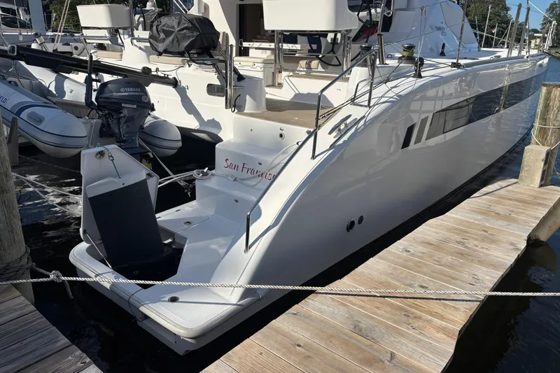 Slide: The Image of 2022 Seawind 1600 catamaran docked, featuring sleek design and modern amenities. - 50