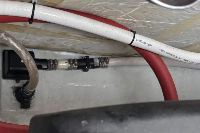 Slide: The Image of Engine compartment of a 2022 Seaway 1600 with hoses and mechanical components. - 58