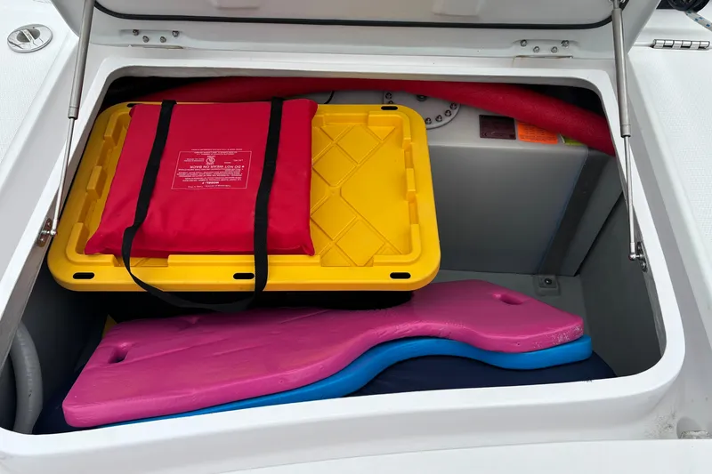 Slide: The Image of Storage compartment of 2022 Seawind 1600 with life jacket and colorful gear. - 61
