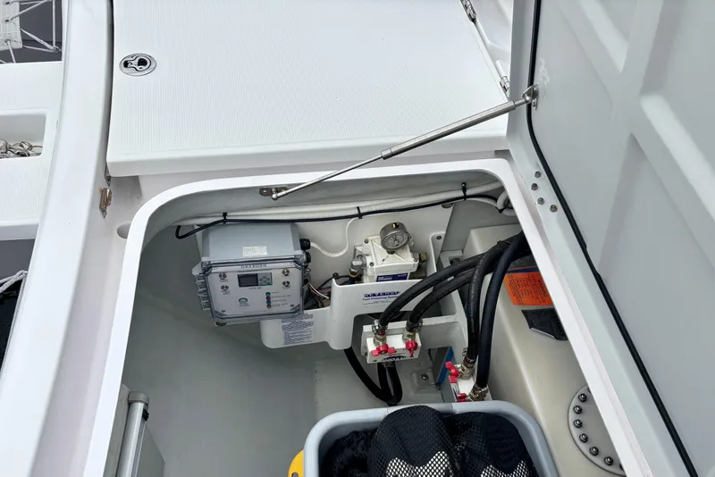 Slide: The Image of 2022 Seawind 1600 yacht compartment with control panel and wiring. - 62
