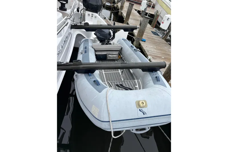Slide: The Image of Inflatable boat docked beside a 2022 Seawind 1600 catamaran. - 63