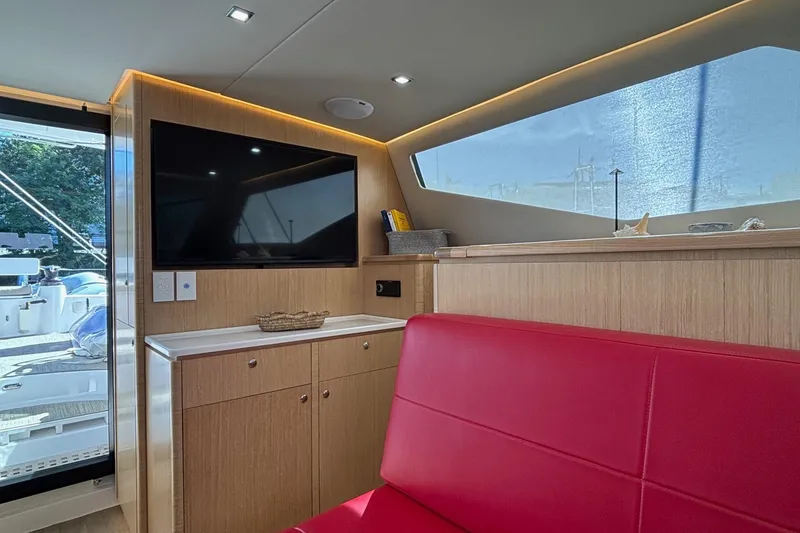 Slide: The Image of Luxurious interior of 2022 Seawind 1600 yacht with red seating and modern amenities. - 9
