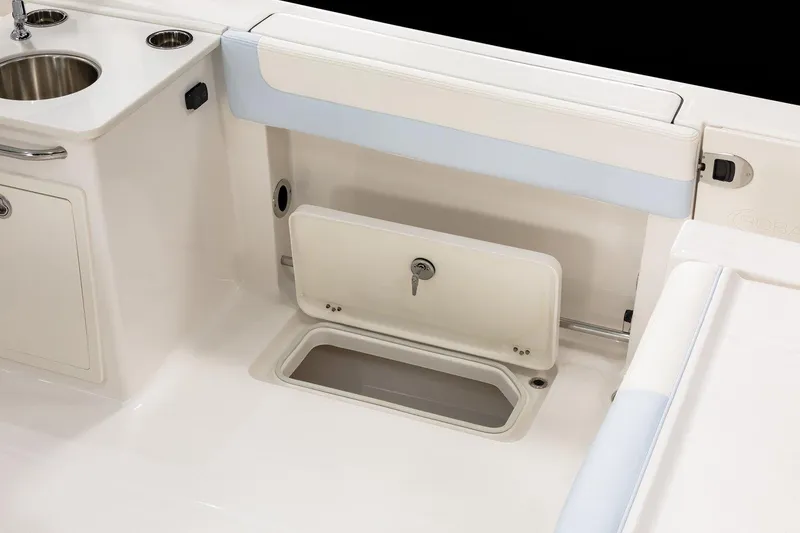 Slide: The Image of 2026 Robalo R257 Dual Console boat interior with storage compartment and sink. - 22