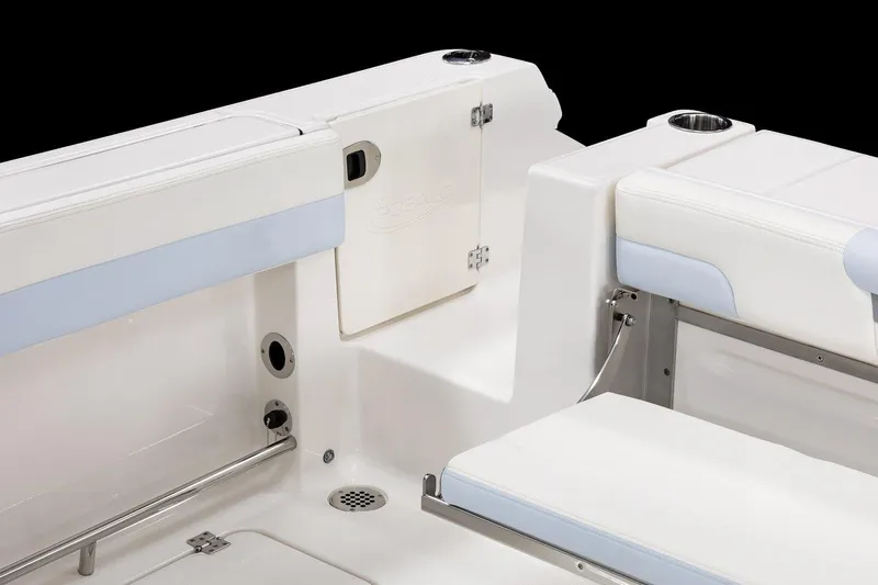 Slide: The Image of 2026 Robalo R257 Dual Console boat interior with white seating and cup holders. - 27