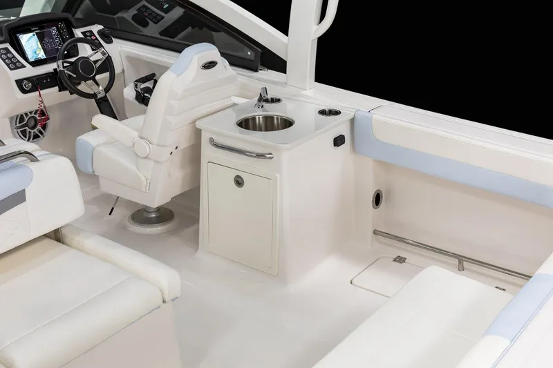 Slide: The Image of 2026 Robalo R257 Dual Console interior with helm, seating, and sink. - 8