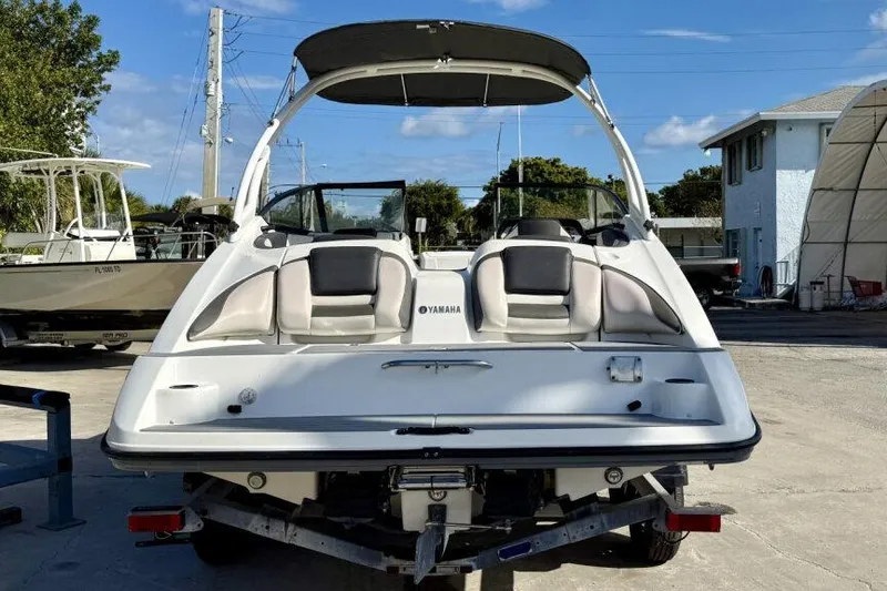 Slide: The Image of 2020 Yamaha AR210 boat with sleek design, parked outdoors under blue sky. - 13