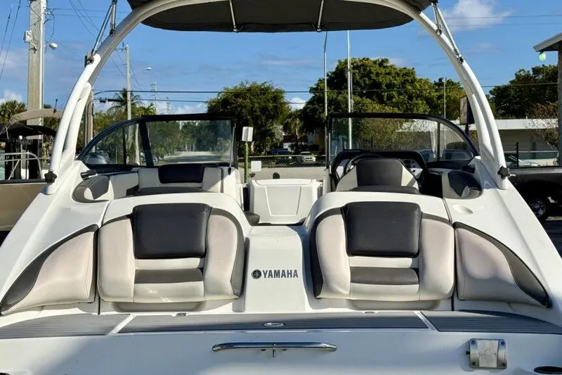 Slide: The Image of 2020 Yamaha AR210 boat interior with cushioned seating and sleek design. - 23