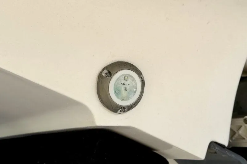 Slide: The Image of Close-up of a 2020 Yamaha AR210 boat's hull with a mounted light fixture. - 24