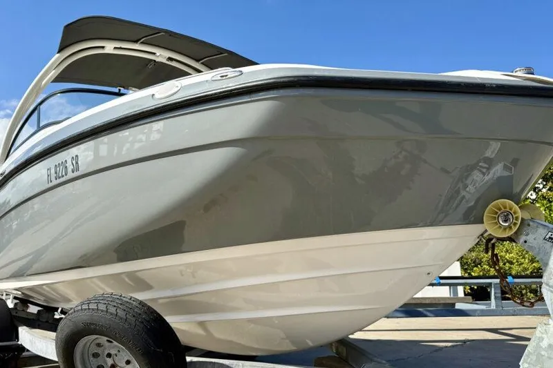 Slide: The Image of 2020 Yamaha Boats AR210 on trailer, sleek design under clear blue sky. - 28