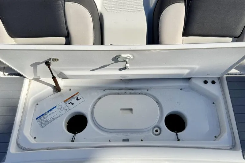 Slide: The Image of Open storage compartment on a 2020 Yamaha AR210 boat, showing interior details. - 32