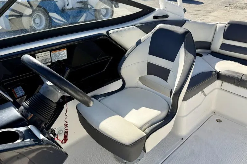 Slide: The Image of 2020 Yamaha Boats AR210 interior with steering wheel and seating area. - 40