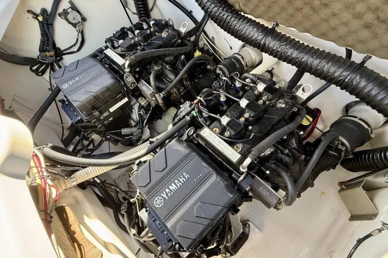 Slide: The Image of 2020 Yamaha AR210 boat engine compartment with dual engines and wiring. - 44