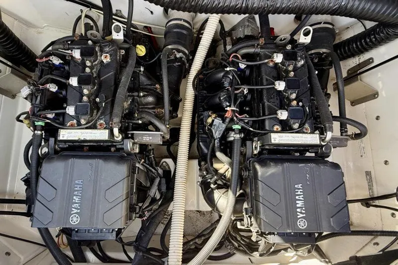 Slide: The Image of 2020 Yamaha AR210 boat engine compartment with dual engines and wiring. - 45