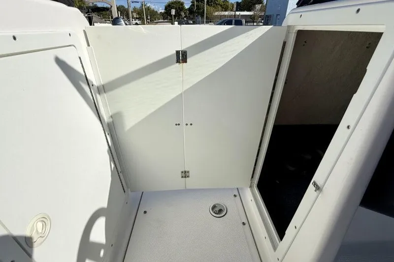 Slide: The Image of 2020 Yamaha Boats AR210 interior storage compartment with open hatch. - 48