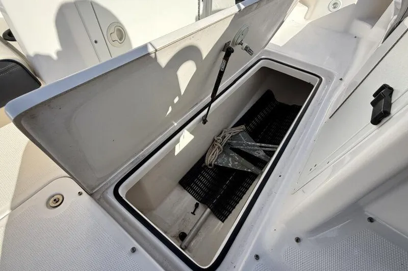 Slide: The Image of Open storage compartment on 2020 Yamaha AR210 boat with anchor inside. - 49