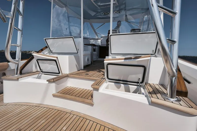 Slide: The Image of 2024 Gamefisherman 49 yacht deck with open storage compartments and sleek design. - 18