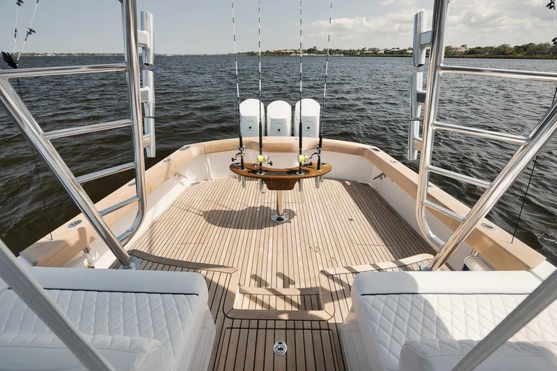Slide: The Image of Luxurious 2024 Gamefisherman 49 yacht deck with fishing rods and seating, on open water. - 19
