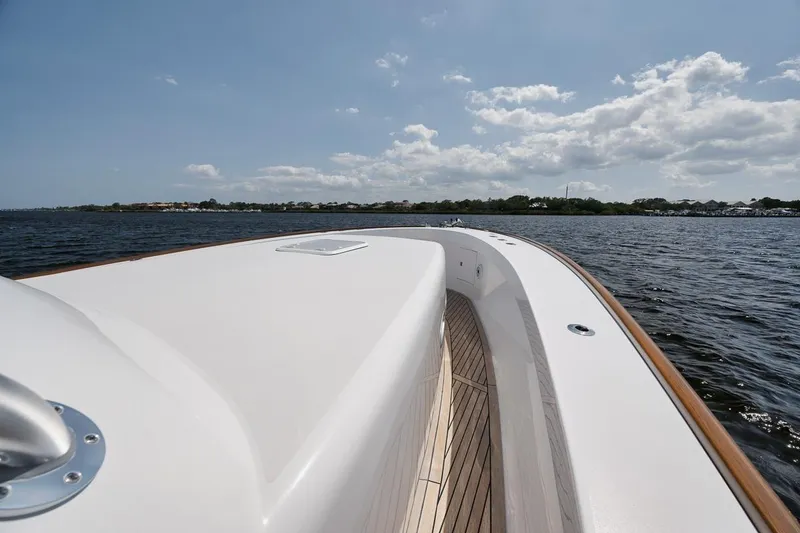 Slide: The Image of 2024 Gamefisherman 49 yacht deck with ocean view under a partly cloudy sky. - 42