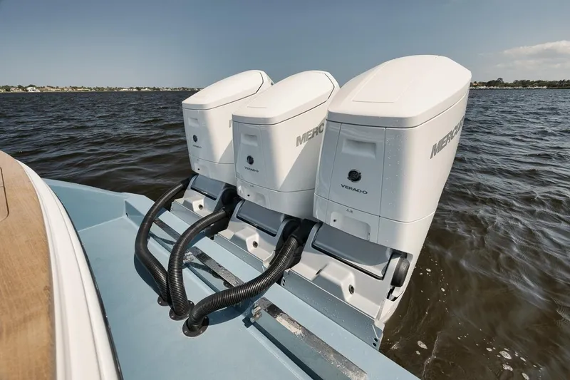 Slide: The Image of Triple Mercury Verado outboard engines on 2024 Gamefisherman 49 boat, cruising on open water. - 46