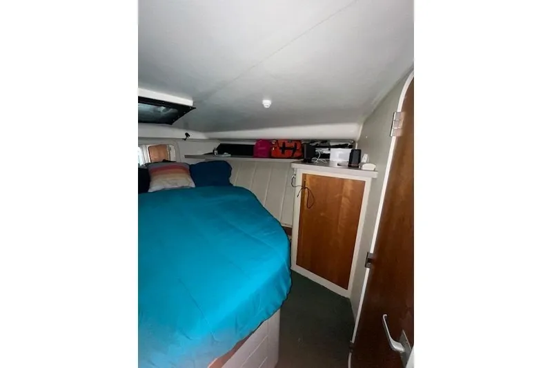 Slide: The Image of 1994 Mainship 40 Sedan Bridge cabin interior with bed and storage. - 14