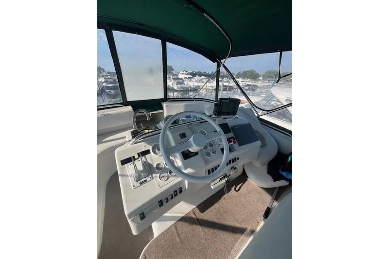 Slide: The Image of 1994 Mainship 40 Sedan Bridge helm with steering wheel and navigation equipment. - 6