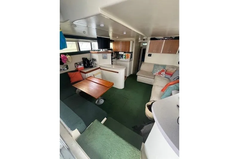 Slide: The Image of 1994 Mainship 40 Sedan Bridge interior with cozy seating and dining area. - 7