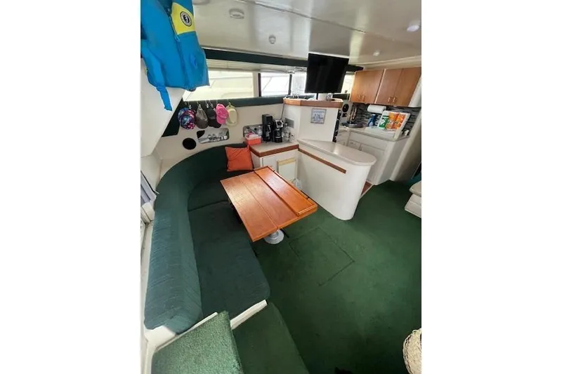 Slide: The Image of Interior of 1994 Mainship 40 Sedan Bridge with cozy seating and kitchenette. - 8