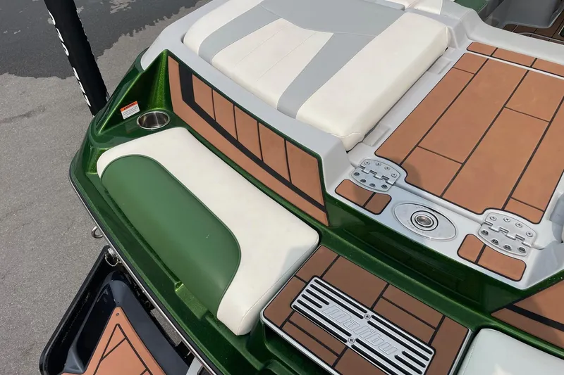 Slide: The Image of 2023 Malibu Wakesetter 24 MXZ boat deck with green and tan seating. - 5