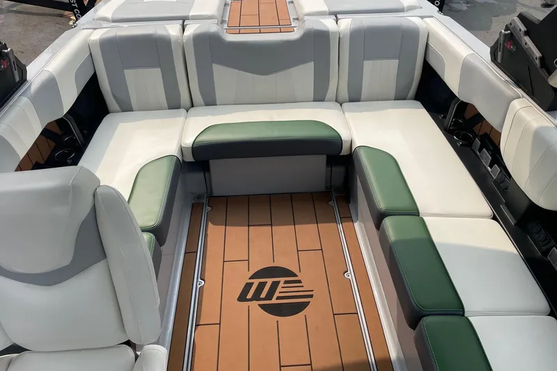 Slide: The Image of 2023 Malibu Wakesetter 24 MXZ interior with stylish seating and wood-patterned flooring. - 6