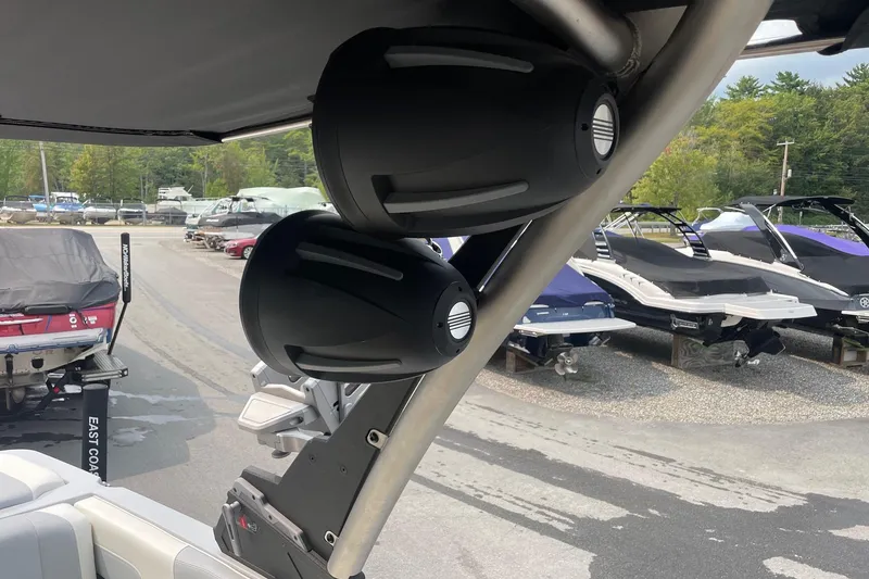 Slide: The Image of 2023 Malibu Wakesetter 24 MXZ boat speakers and interior view at a marina. - 7