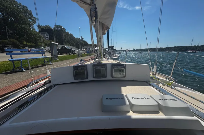 Slide: The Image of 2003 J Boats J/105 sailboat deck with Raymarine instruments, docked by the water. - 11
