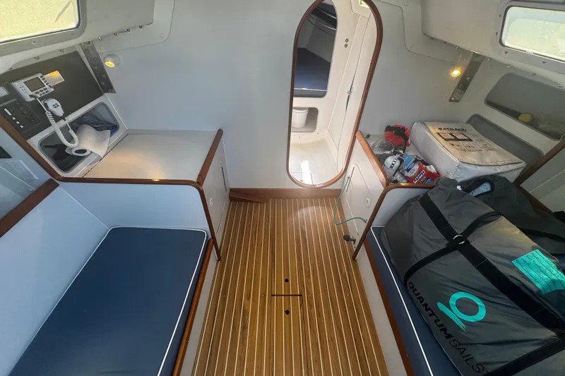 Slide: The Image of Interior of 2003 J Boats J/105 sailboat with wooden flooring and seating. - 12