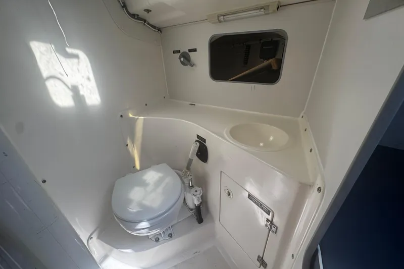 Slide: The Image of Compact marine bathroom in a 2003 J Boats J/105, featuring a toilet and sink. - 14