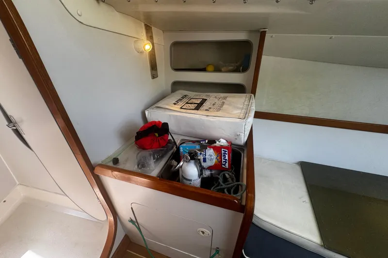 Slide: The Image of 2003 J Boats J/105 cabin interior with storage and safety equipment. - 17
