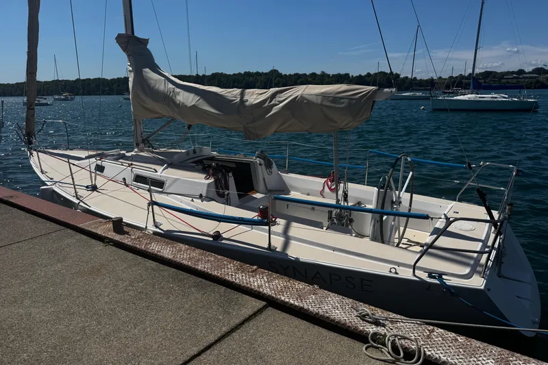 Slide: The Image of 2003 J Boats J/105 sailboat docked by the water on a sunny day. - 2
