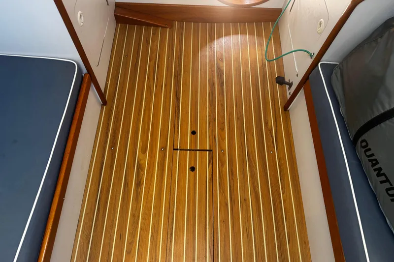 Slide: The Image of Interior view of 2003 J Boats J/105 with wooden flooring and cushioned seating. - 20