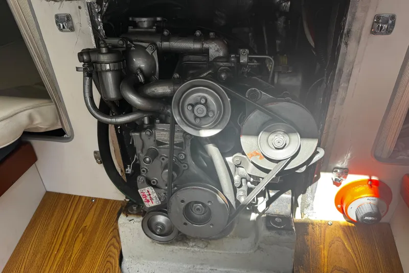 Slide: The Image of Engine compartment of a 2003 J Boats J/105 sailboat, showcasing mechanical components. - 22