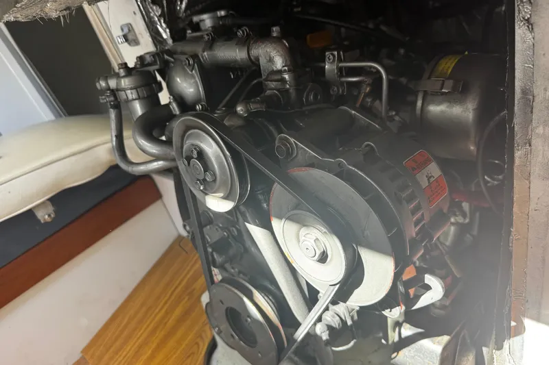 Slide: The Image of Engine compartment of a 2003 J Boats J/105 sailboat, showcasing mechanical components. - 23