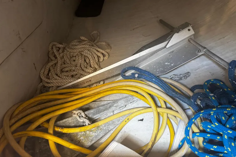 Slide: The Image of Storage compartment of a 2003 J Boats J/105 with ropes and anchor. - 24