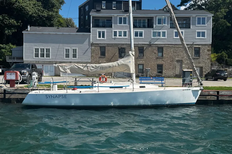 Slide: The Image of 2003 J Boats J/105 sailboat docked by waterfront buildings. - 34