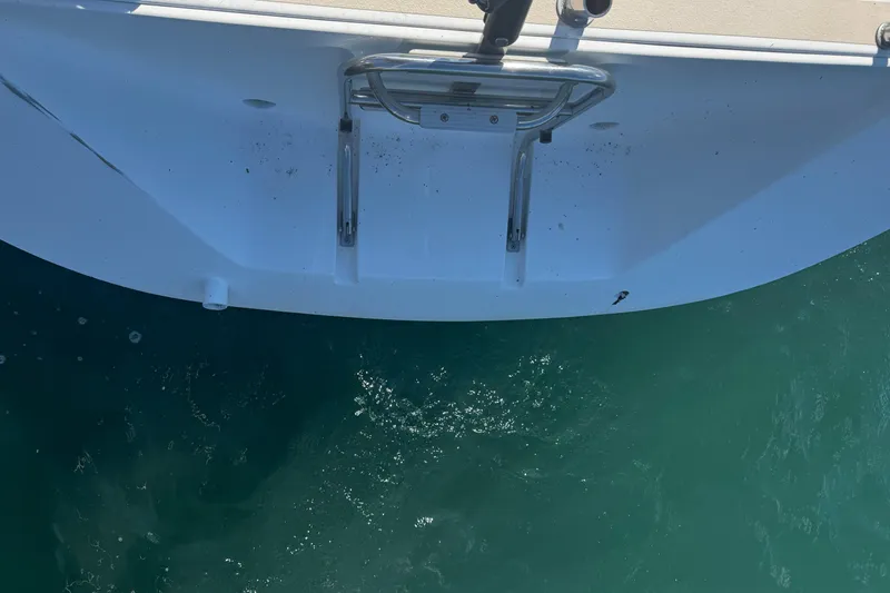 Slide: The Image of 2003 J Boats J/105 stern view with swim ladder over clear water. - 8