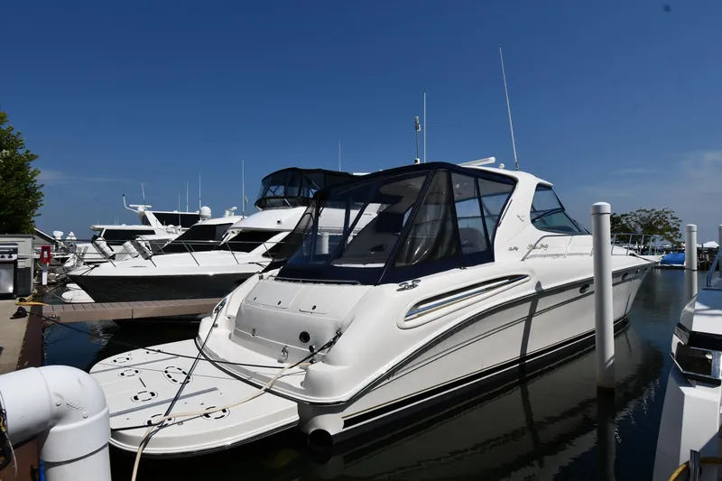 Slide: The Image of 2001 Sea Ray 540 Sundancer yacht docked at marina under clear blue sky. - 1