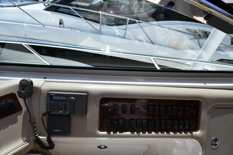 Slide: The Image of Control panel of a 2001 Sea Ray 540 Sundancer yacht, featuring communication equipment and switches. - 16